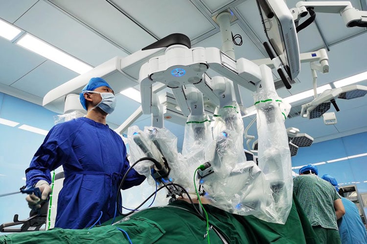 Surgeons operate a da Vinci Surgical robot during a surgical operation at Qinghai Provincial People's Hospital
